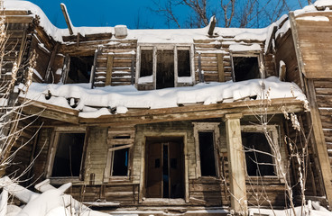 old wooden ruined barracks at winter night