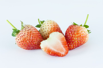 Strawberries Berries with a half section on white