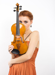 Young red-haired girl with a violin in her hands
