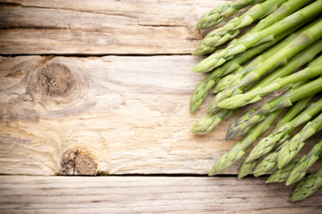 Asparagus on the wooden background.