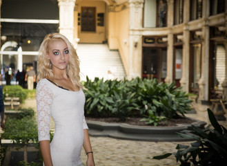 Elegant pretty blonde young woman at posh city setting in Europe