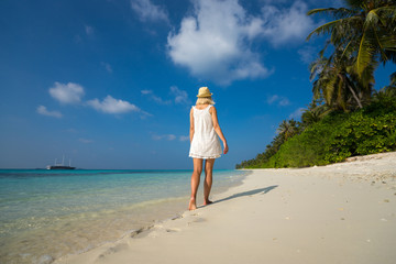 woman in a white dress on the tropical beach