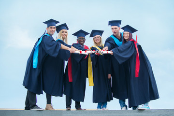 group of graduates celebrating outdoors