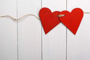Two red hearts tied together
