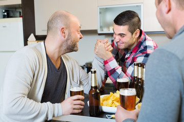 Friends armwrestling at the table
