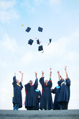 group of graduates celebrating outdoors