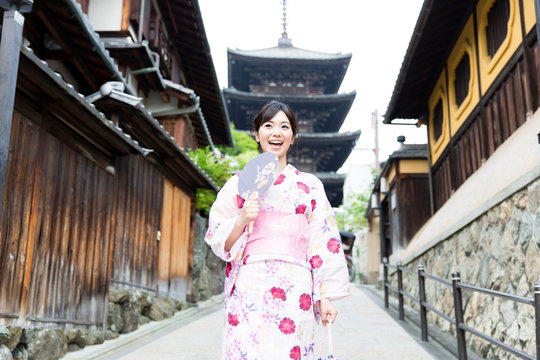 young asian woman wearing kimono walking
