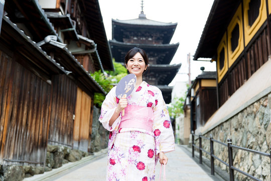 young asian woman wearing kimono walking
