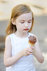 Adorable little girl eating ice cream