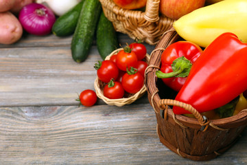 Fresh organic vegetables and fruits on wooden background