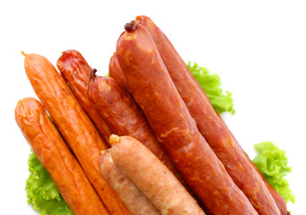 Assortment of thin sausages  with lettuce salad leaves,