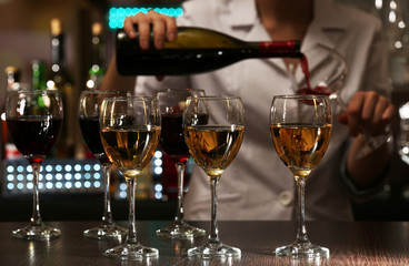 Bartender working at counter on bar background