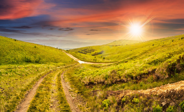path through highland meadows at sunset