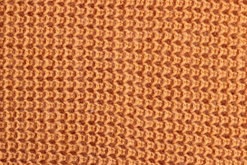Texture of a orange knitted sweater