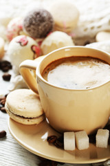 Gentle colorful macaroons and  coffee in mug