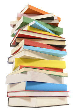 Very tall stack of colorful books low view looking up isolated white background photo
