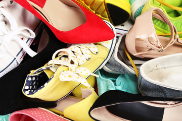 Many various female shoes close-up background