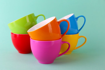 Colorful cups on color background