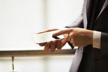 Close up of a man using mobile smart phone