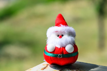 Obraz premium Santa doll in the park outdoor with sunlight.