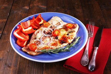 Dish of Pangasius fillet with spices and vegetables