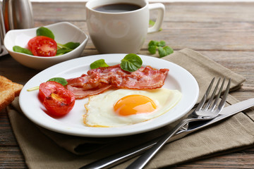 Bacon and eggs on rustic wooden planks background