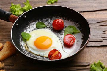 Bacon and eggs on rustic wooden planks background