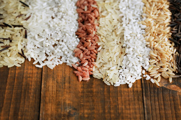 Obraz na płótnie Canvas Different types of rice on wooden background