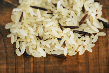 Rice grains on wooden background