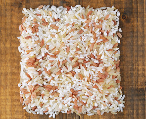 Rice grains on wooden background