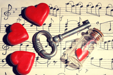 Retro key with hearts and small glass bottle