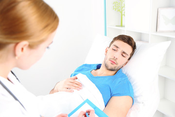 Obraz premium Doctor filling medical report for her patient close up