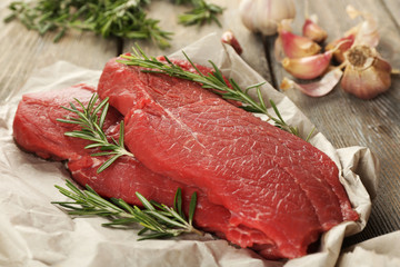 Raw beef steak with rosemary and garlic