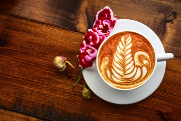 cup of cappuccino on a wooden table