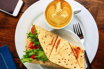 Breakfast with cappuccino and sandwich