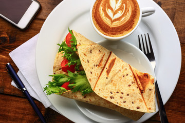 Breakfast with cappuccino and sandwich