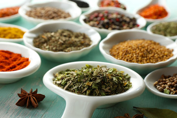 Different kinds of spices in ceramics spoons, close-up,