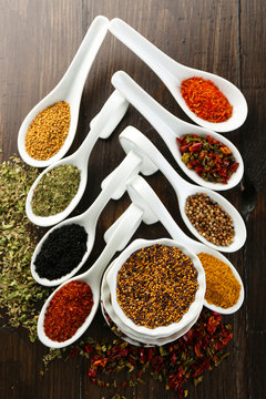 Different kinds of spices in ceramics spoons, close-up,