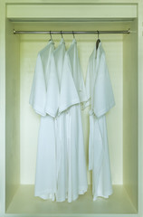 dressing gown hanging in a white wardrobe