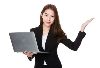 Businesswoman hold with laptop and open hand palm