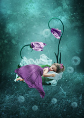 Sleeping little girl in magical forest