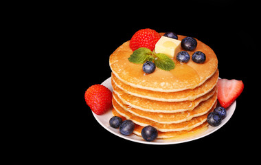 Pancakes with Strawberry and Blueberry over black background