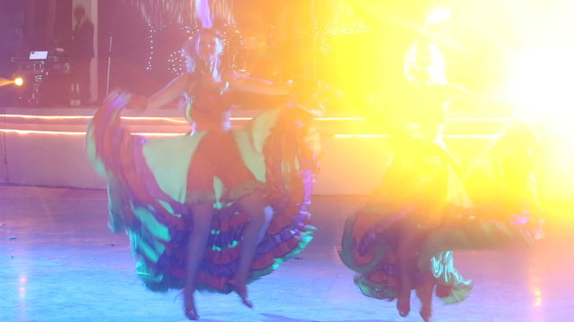 two girls in cabaret costumes dance cancan	
