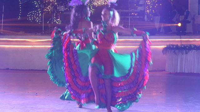 two girls in cabaret costumes dance cancan	