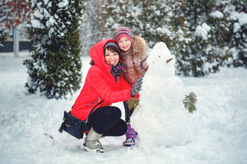 Fototapeta na wymiar Happy mother and kid playing on snow