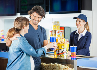 Expectant Couple Buying Snacks At Concession Stand © Tyler Olson