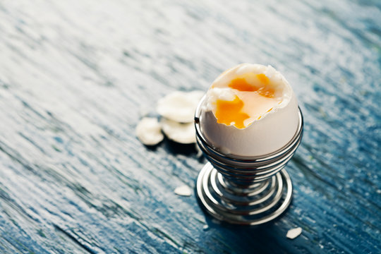 Open soft boiled egg in egg cup