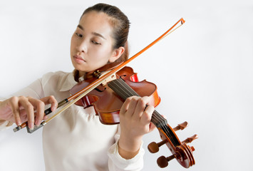 Beautiful young woman playing violin over white background - 78035009