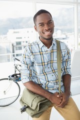 Cheerful businessman posing with shoulder bag