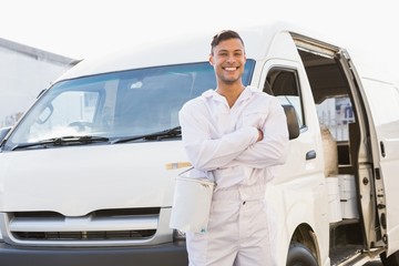 Painter smiling leaning against his van